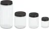 Four glass jars of varying sizes with black lids are arranged in a row against a white background. Náhled obrázku produktu