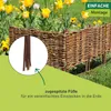 A woven willow garden border with tulips in the background. Produktbild-Vorschau