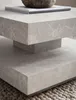 A close-up view of a modern, square coffee table with a marble-like finish, resting on a textured rug. Produktbild-Vorschau