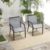 Two outdoor chairs are placed on a patio with plants in the background. Produktbild-Vorschau