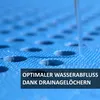 Close-up of a blue textured surface with circular holes, with water flowing over it. Produktbild-Vorschau
