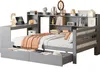 A grey wooden bed frame with a built-in desk and shelving unit, featuring drawers underneath the bed. The bed is made and has an orange throw blanket and pillows. Produktbild-Vorschau