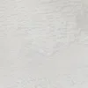 A close-up view of a white shaggy rug. Voir les images du produit