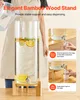A person pouring liquid into a glass beverage dispenser on a wooden stand, with inset images showing dispensing with and without the stand. Produktbild-Vorschau