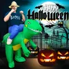 A person wearing a Halloween costume rides an inflatable dinosaur in front of a spooky Halloween scene with pumpkins and bats. Náhled obrázku produktu