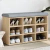 A shoe rack with a padded seat on top, filled with various shoes. Anteprima dell’immagine prodotto