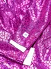 A close-up view of a pink suit with a textured pattern. Produktbild-Vorschau