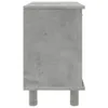 A side view of a gray cabinet with a concrete texture, standing on four cylindrical legs. Produktbild-Vorschau