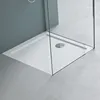 A close-up view of a white rectangular shower tray with a drain, enclosed by glass shower walls. Produktbild-Vorschau
