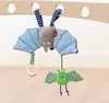 Two plush bat toys hanging from a wooden bar. Produktbild-Vorschau