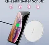 A smartphone is shown being wirelessly charged on a white charging pad. The phone displays a charging icon and the time. Produktbild-Vorschau