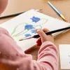 A child painting a picture of flowers. Produktbild-Vorschau