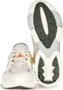 A pair of Lacoste sneakers, one shown from the front and the other from the sole. Produktbild-Vorschau