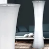A floor lamp is shown in a living room setting with a sofa and coffee table in the background. Produktbild-Vorschau
