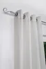 A close-up view of a silver curtain rod with white curtains hanging from it. Produktbild-Vorschau