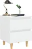 A white nightstand with two drawers and wooden legs, a lamp, and a plant in a vase. Náhled obrázku produktu
