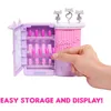 A hand is shown interacting with a toy nail salon playset, displaying its storage and display features. Podgląd zdjęcia produktu