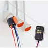 Electrical adapters and a testing device are shown in a close-up shot against a white background. Produktbild-Vorschau