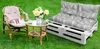 Outdoor seating area with a cat on a chair, a small table with flowers, and a pallet sofa. Produktbild-Vorschau