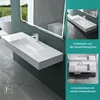 A modern bathroom with a wall-mounted sink and a large illuminated mirror. Produktbild-Vorschau