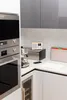 A modern kitchen counter with appliances and accessories. Voir les images du produit