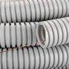 A close-up view of coiled grey corrugated plastic tubing with a copper wire threaded through one of the tubes. Produktbild-Vorschau