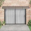 A vidaXL door canopy is installed above a sliding glass door on a brick wall. Náhled obrázku produktu
