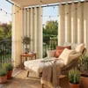 A cozy outdoor seating area on a balcony or patio, furnished with a chaise lounge, plants, and string lights. Náhled obrázku produktu