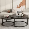 A living room scene with a sofa and two round coffee tables. Produktbild-Vorschau