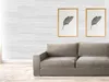 A living room scene with a sofa and artwork on a wood-paneled wall. Anteprima dell’immagine prodotto