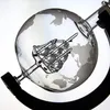 A close-up shot of a glass globe decanter with a world map etched onto it, containing a metal cage-like structure inside. Produktbild-Vorschau
