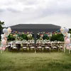 An outdoor party setup with a large tent, tables, chairs, and balloon decorations. Náhled obrázku produktu