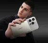A young man holding a phone with a power bank attached to the back. Produktbild-Vorschau