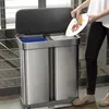 A person is shown scraping food from a plate into a dual-compartment trash can. Podgląd zdjęcia produktu