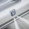 A close-up view of a white cleaning robot with a blue nozzle spraying water. Produktbild-Vorschau