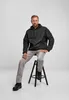 A man is sitting on a stool wearing a black jacket and grey pants. Anteprima dell’immagine prodotto