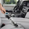 A hand is using a cordless vacuum cleaner to clean the interior of a car. Produktbild-Vorschau