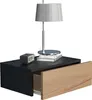 A modern black nightstand with a light wood drawer front, a lamp, and a small alarm clock on top. Produktbild-Vorschau