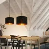 A dining room with a table and chairs, illuminated by two pendant lights. Anteprima dell’immagine prodotto