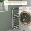 A folded drying rack is shown next to a washing machine in a laundry room. Anteprima dell’immagine prodotto