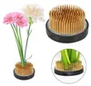 A collage of images showing a flower frog (also known as a kenzan or flower holder) with and without flowers. Produktbild-Vorschau