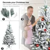 A family decorating a Christmas tree. Produktbild-Vorschau