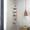 A corner shelf unit with decorative items on it, next to a window and a cabinet. Produktbild-Vorschau
