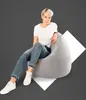 A woman is sitting on a beanbag chair against a gray background with a white geometric shape behind her. Produktbild-Vorschau