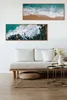 A living room scene with a sofa, coffee table, and artwork on the wall. Produktbild-Vorschau