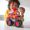 A young boy is playing with a toy fire truck. Produktbild-Vorschau