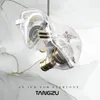 A pair of transparent in-ear headphones with gold accents, presented against a soft, abstract background with flowing lines and gold accents. Produktbild-Vorschau