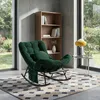 A cozy reading nook with a green rocking chair, bookshelf, and a small side table with a lamp. Produktbild-Vorschau