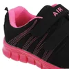 A close-up view of a black and pink children's sneaker. Produktbild-Vorschau