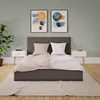A bedroom scene with a bed, nightstands, and artwork. Produktbild-Vorschau